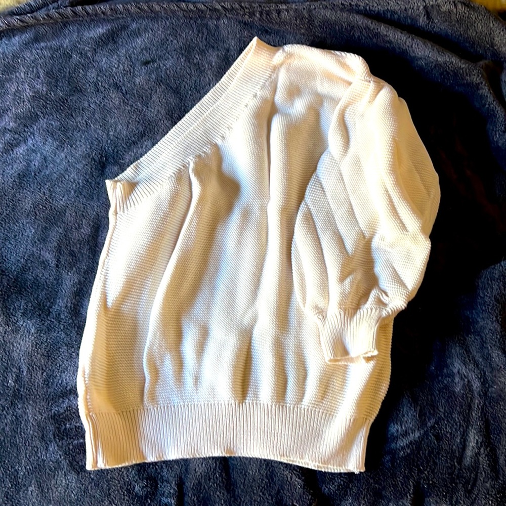 Cream color, one sleeve, quarter length bubble sleeve sweater.